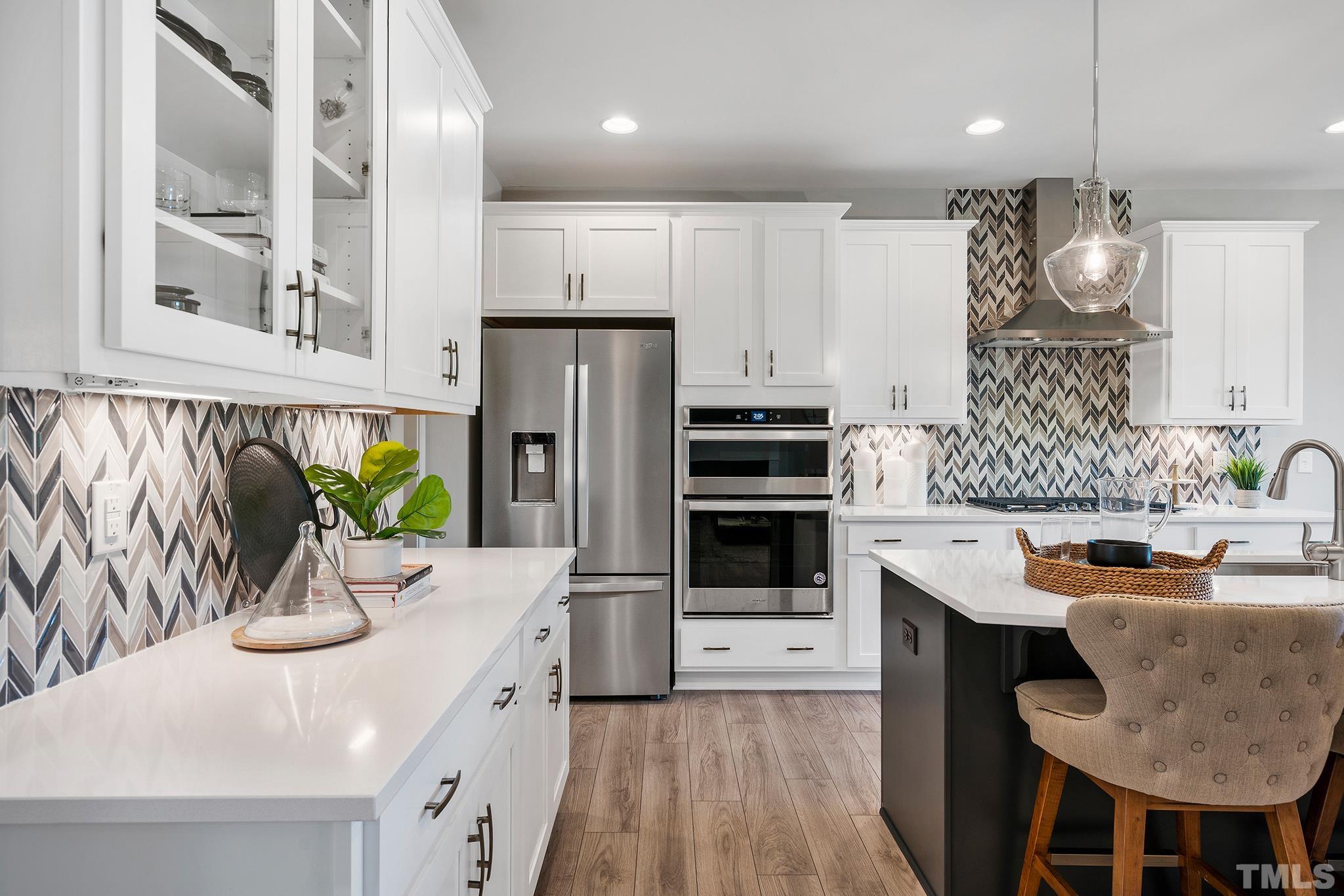 1016 Manchaca Loop, Unit 4 Apex, NC 27539 - Photo 3 of 36 a kitchen with stainless steel appliances granite countertop a sink refrigerator and microwave