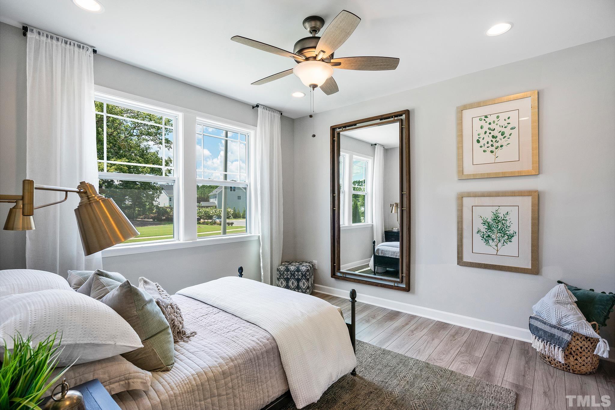 1016 Manchaca Loop, Unit 4 Apex, NC 27539 - Photo 31 of 36 a bedroom with two beds and a large window