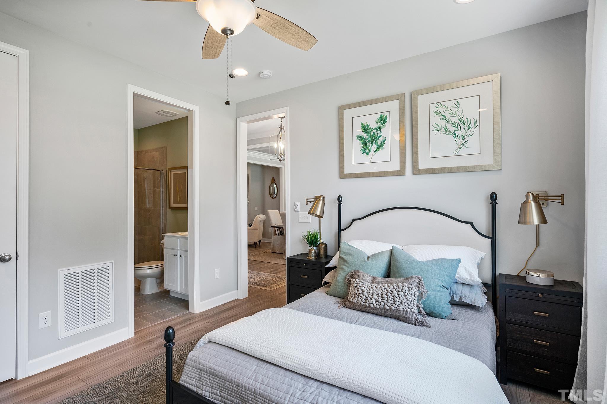 1016 Manchaca Loop, Unit 4 Apex, NC 27539 - Photo 32 of 36 a bedroom with a bed and a mirror