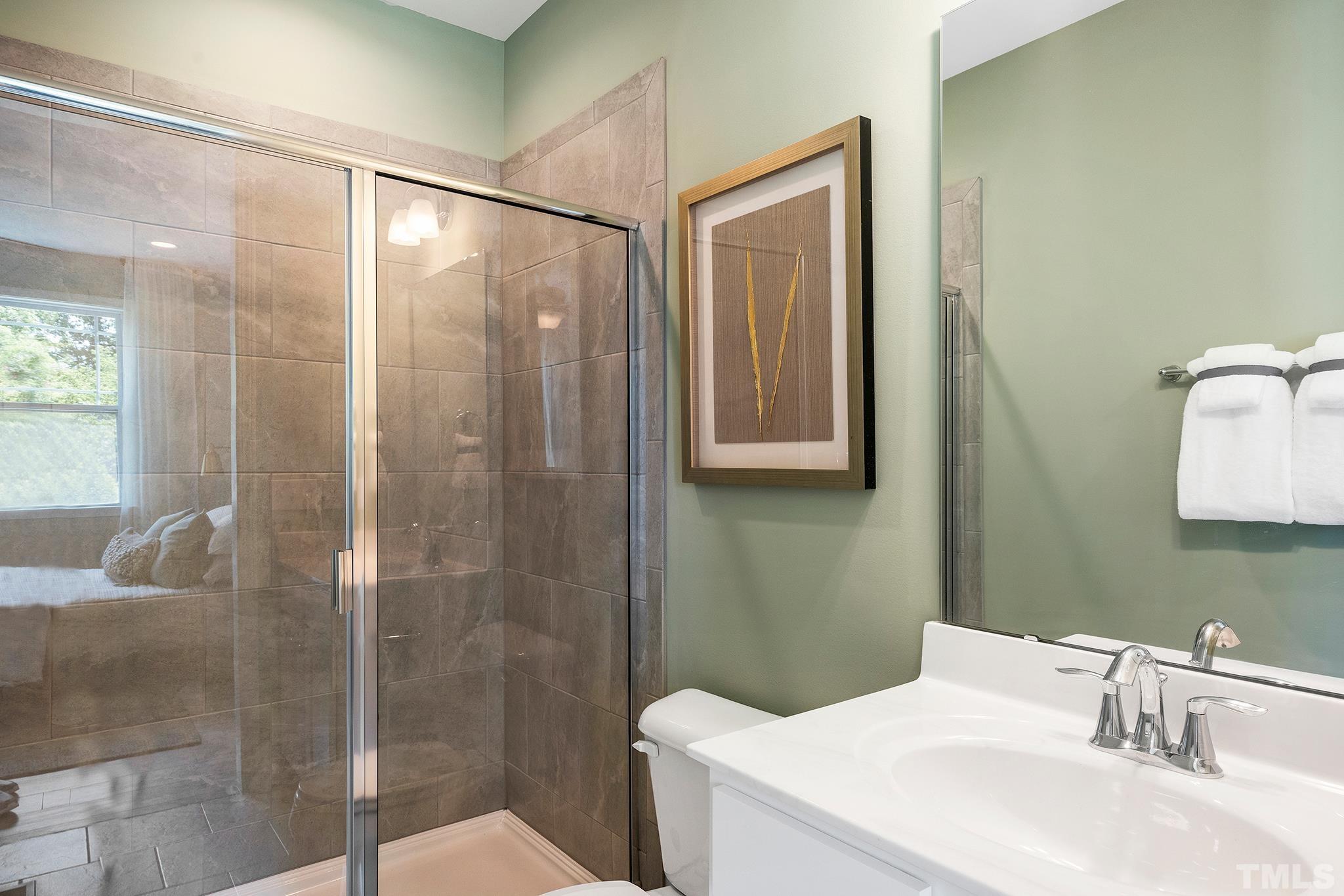 1016 Manchaca Loop, Unit 4 Apex, NC 27539 - Photo 33 of 36 a bathroom with a sink toilet and shower