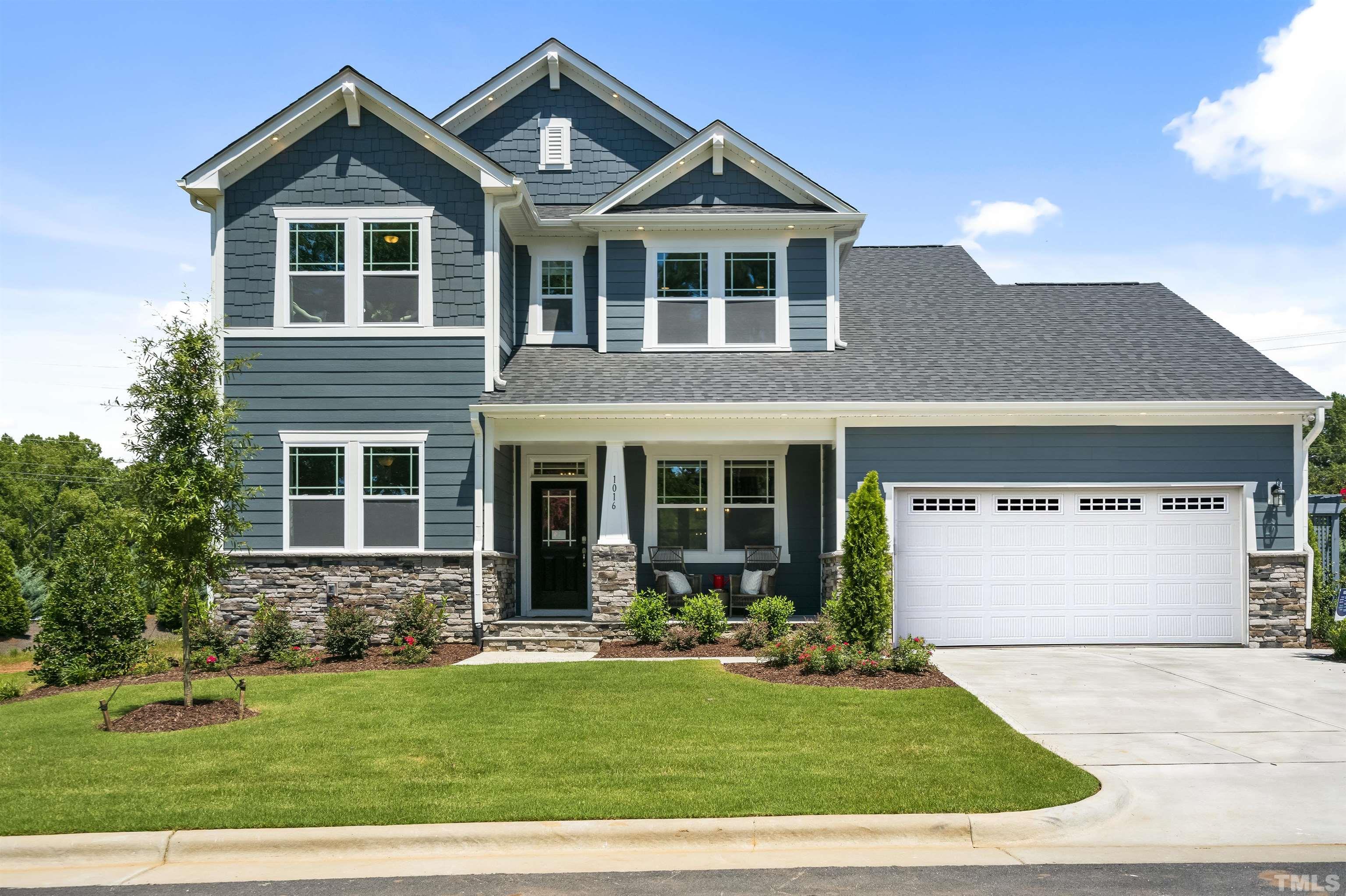 1016 Manchaca Loop, Unit 4 Apex, NC 27539 - Photo 34 of 36 a front view of a house with a yard