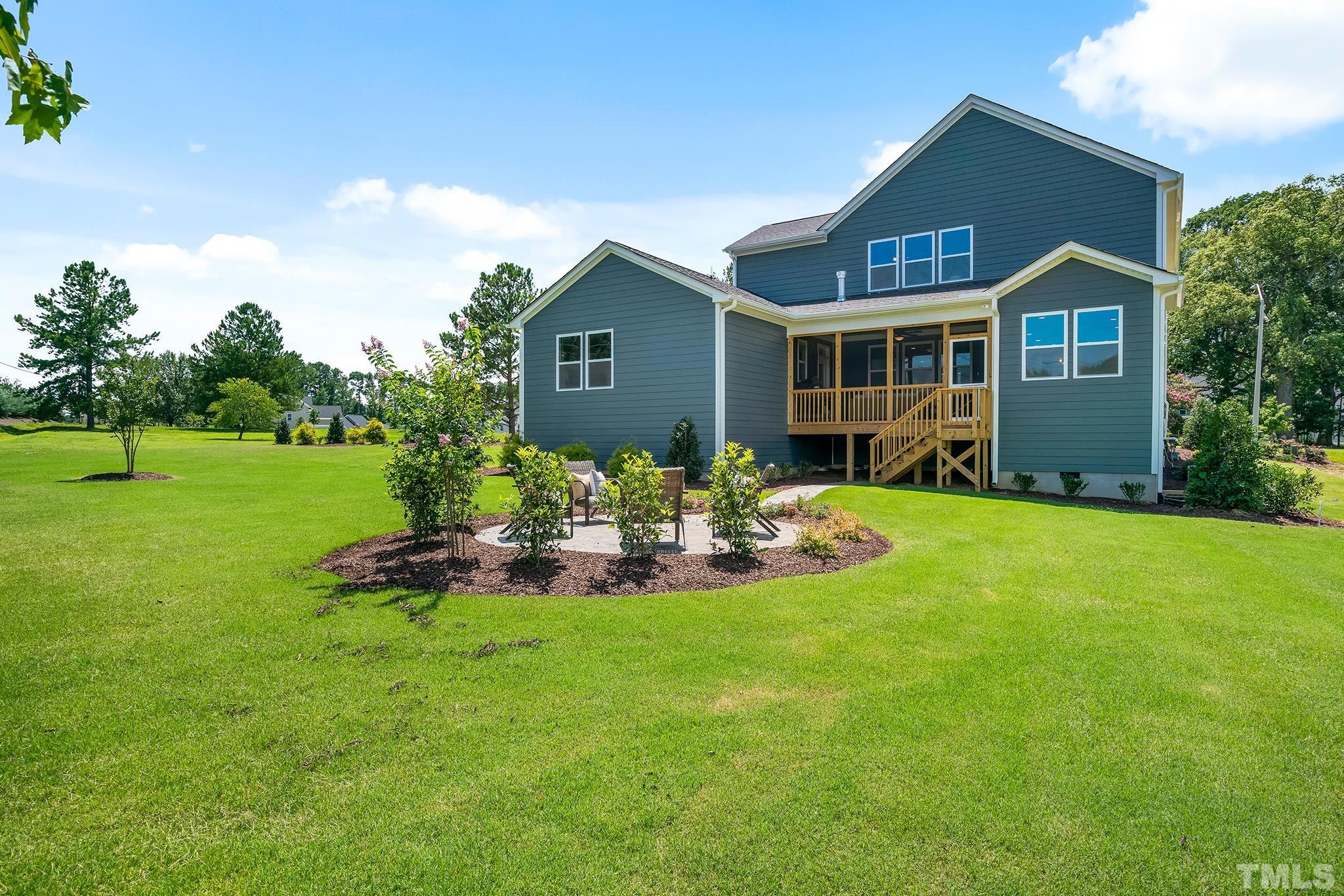 1016 Manchaca Loop, Unit 4 Apex, NC 27539 - Photo 35 of 36 a front view of a house with patio and yard