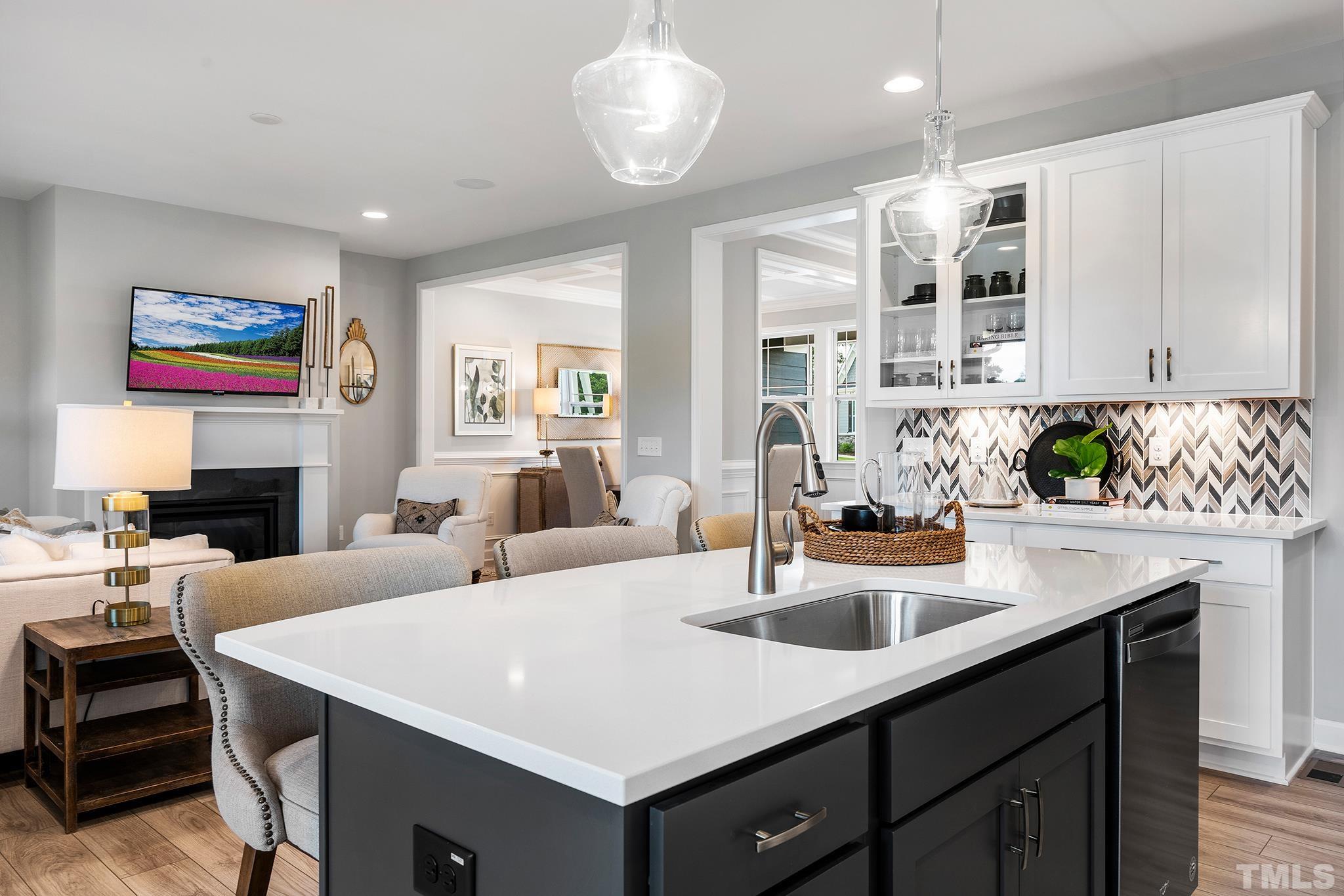 1016 Manchaca Loop, Unit 4 Apex, NC 27539 - Photo 6 of 36 a view of center kitchen island a sink a stove and a refrigerator