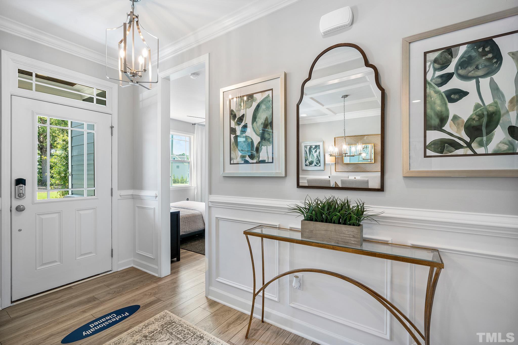 1016 Manchaca Loop, Unit 4 Apex, NC 27539 - Photo 7 of 36 a living room with furniture a chandelier and a window