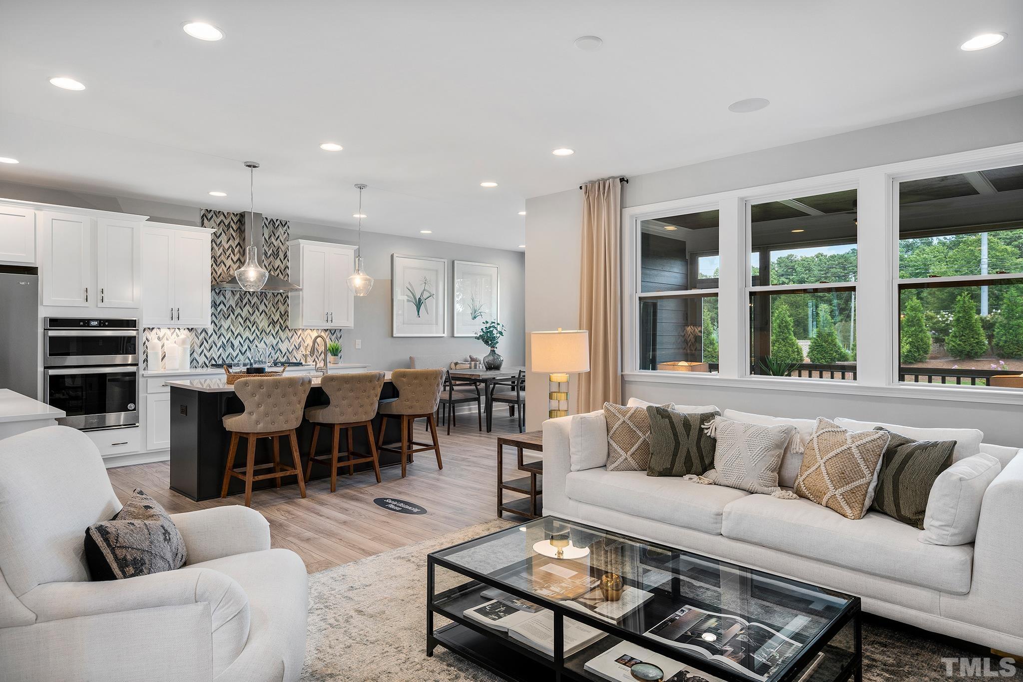 1016 Manchaca Loop, Unit 4 Apex, NC 27539 - Photo 10 of 36 a living room with furniture kitchen view and a large window