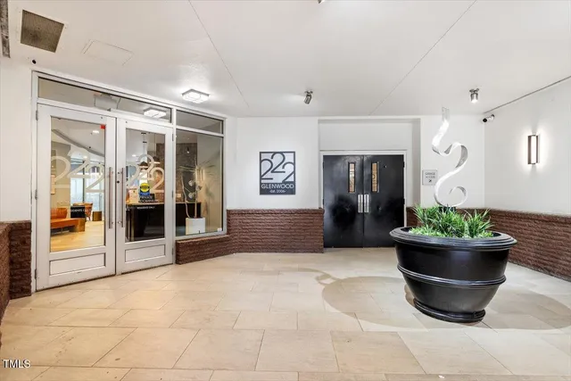 a living room with furniture and potted plant