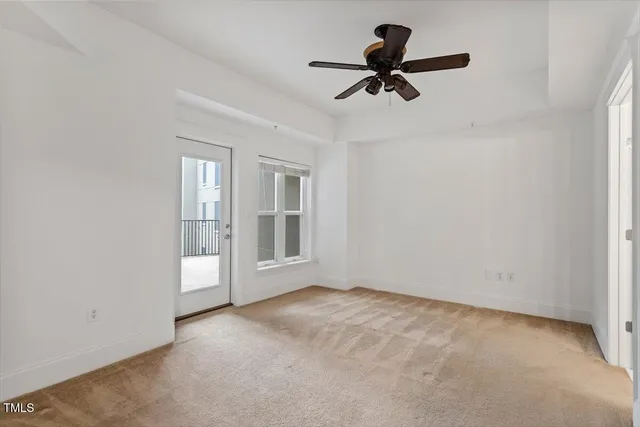 a view of room with a ceiling fan and window