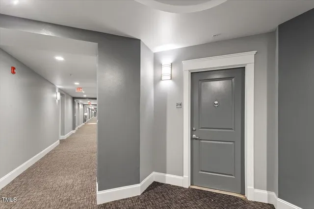 a room with stainless steel appliances kitchen island a chandelier