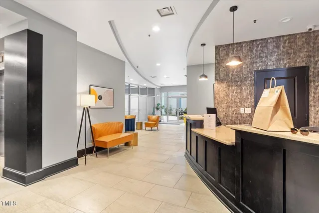 a living room with furniture a lamp and a potted plant