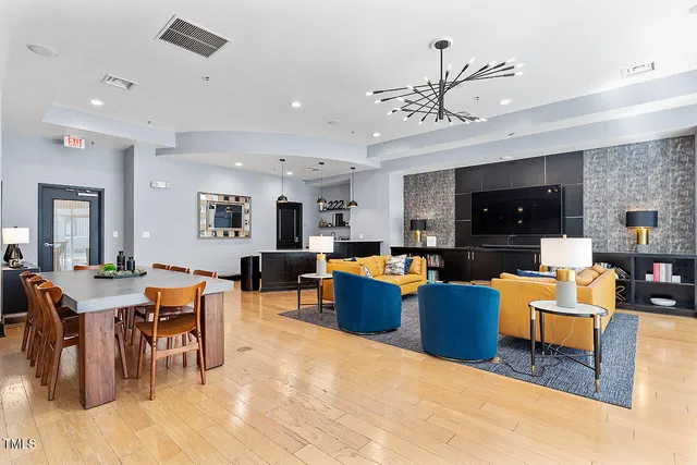 a living room filled with furniture and a chandelier
