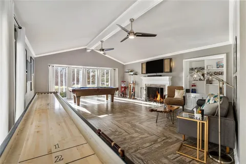 a living room with fireplace furniture and a flat screen tv
