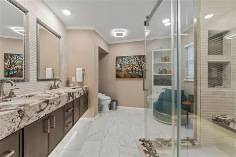 a spacious bathroom with a granite countertop sink mirror and shower