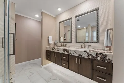 a spacious bathroom with a granite countertop sink a mirror and a