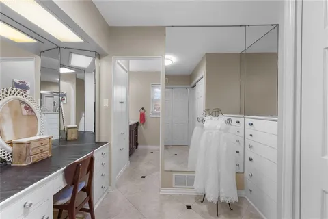 a bathroom with a double vanity sink mirror and shower