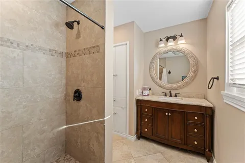 a bathroom with a double vanity sink and a mirror
