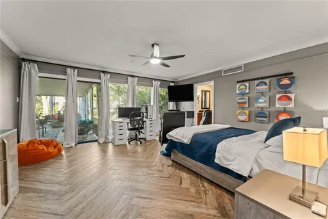 a bedroom with a bed and wooden floor