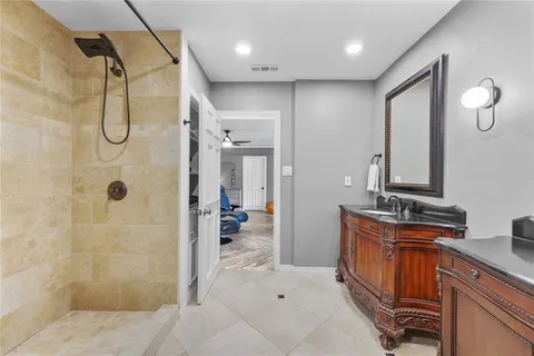 a bathroom with a double vanity sink a mirror and shower