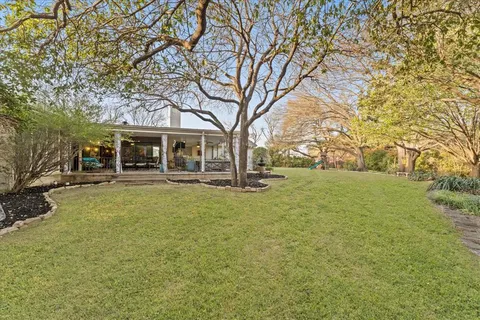 a view of a chair and tables in the patio