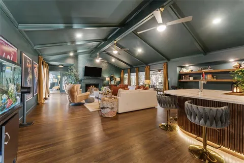 a living room with lots of furniture and a flat screen tv