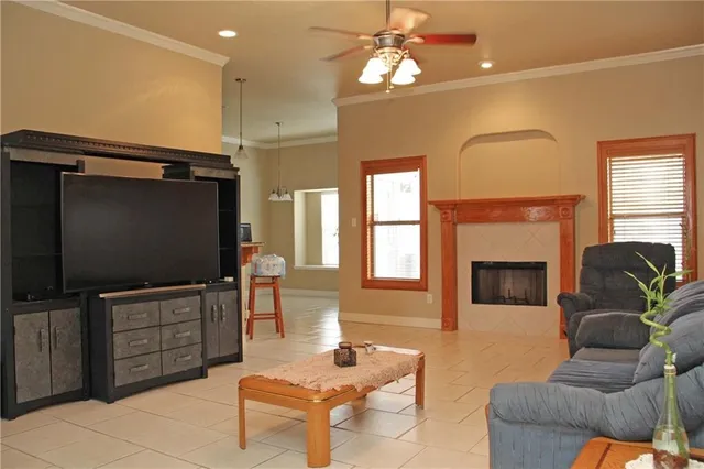 a living room with furniture a fireplace and a flat screen tv