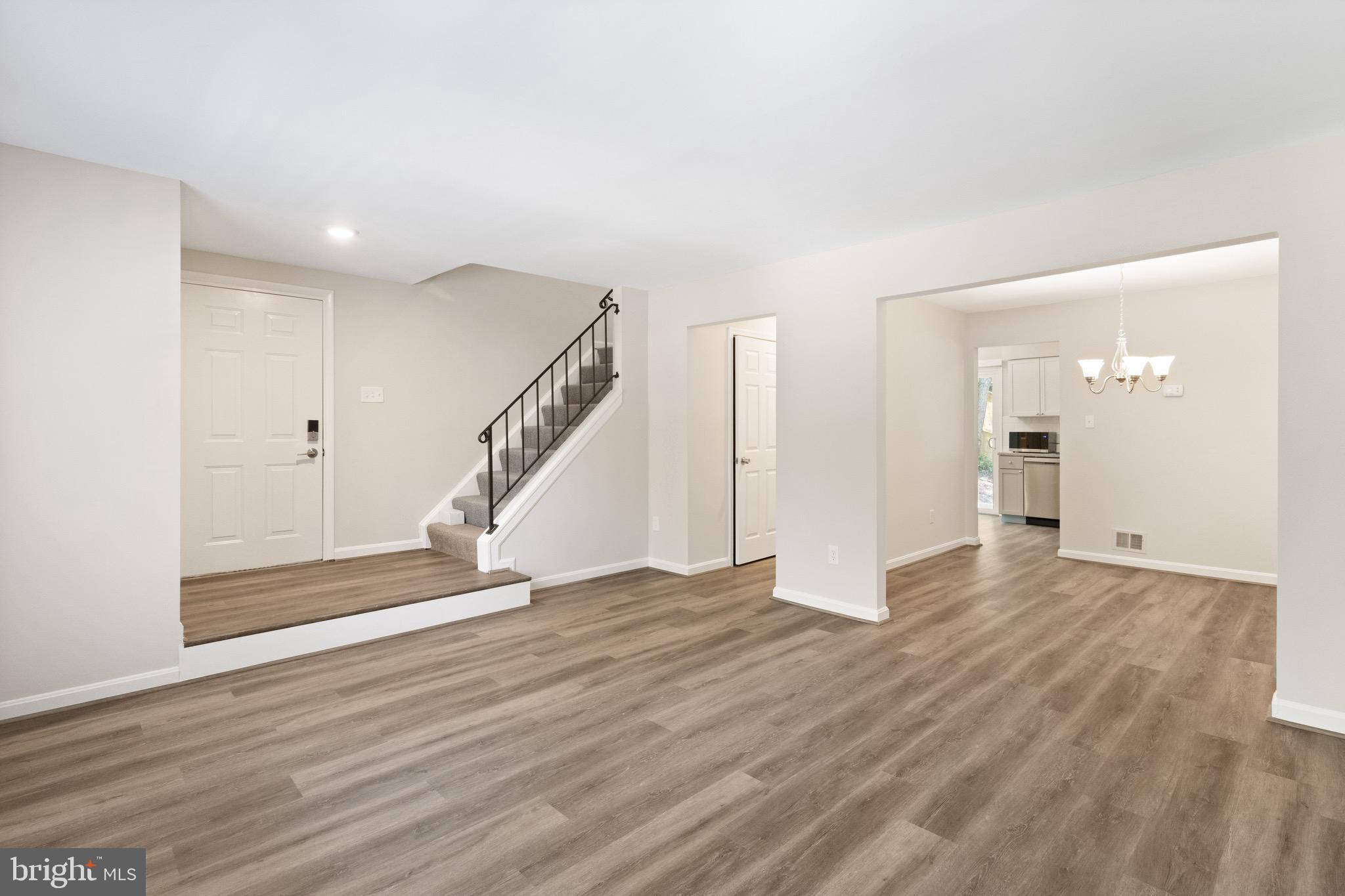 8581 Chester Grove Court Springfield, VA 22153 - Photo 3 of 38 a view of empty room with wooden floor and stairs