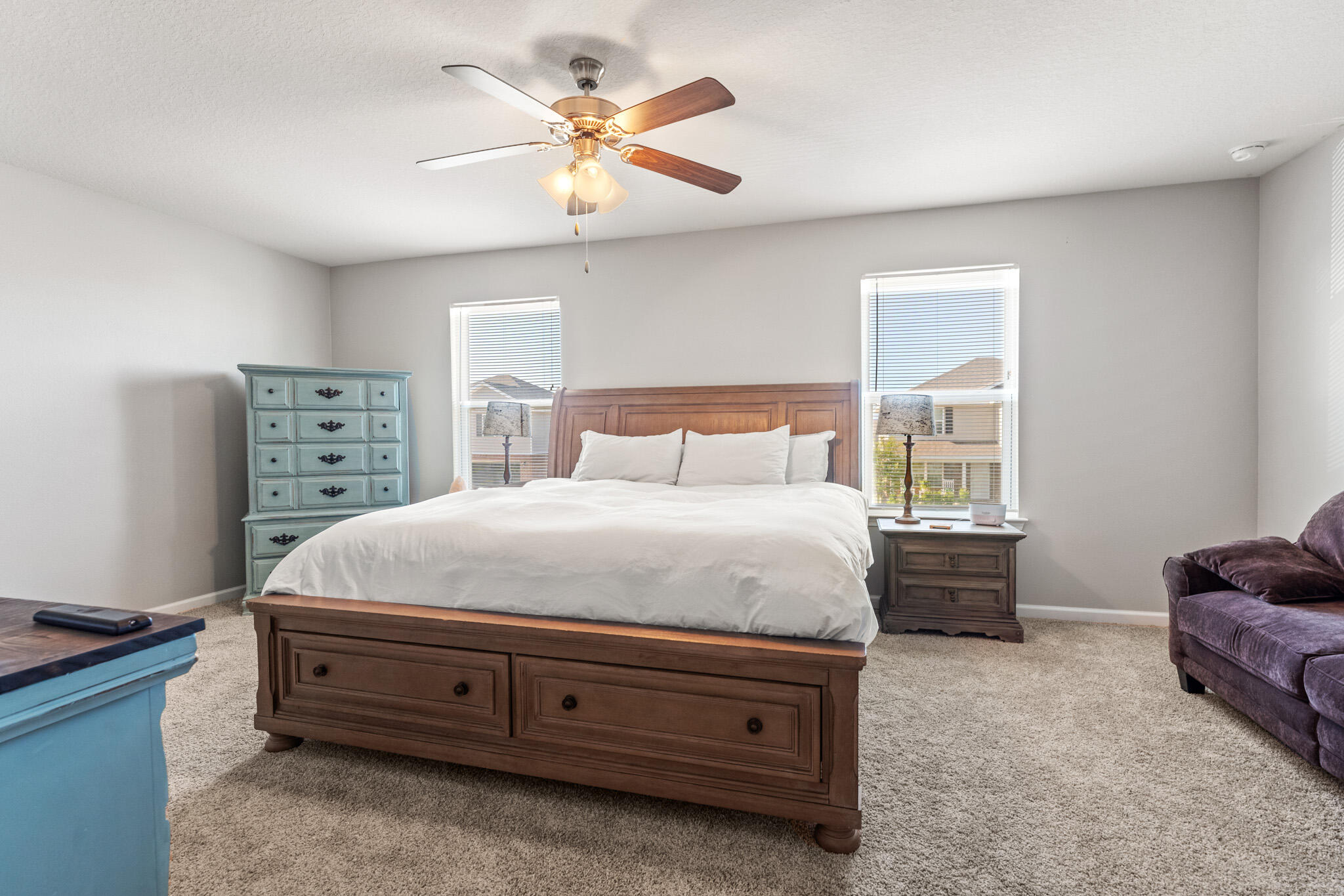 745 Widgeon Way Crestview, FL 32539 - Photo 13 of 29 a spacious bedroom with a bed and a chandelier