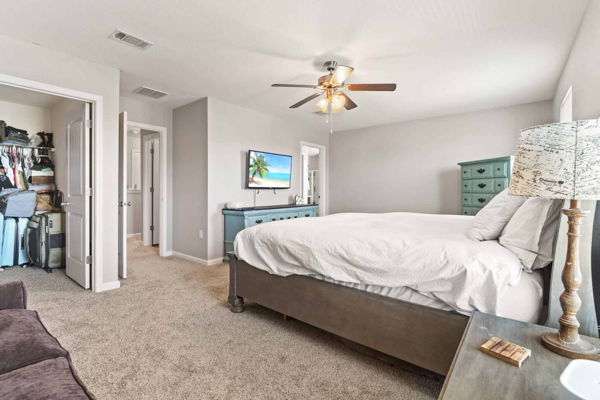 745 Widgeon Way Crestview, FL 32539 - Photo 15 of 29 a spacious bedroom with a bed and a chandelier