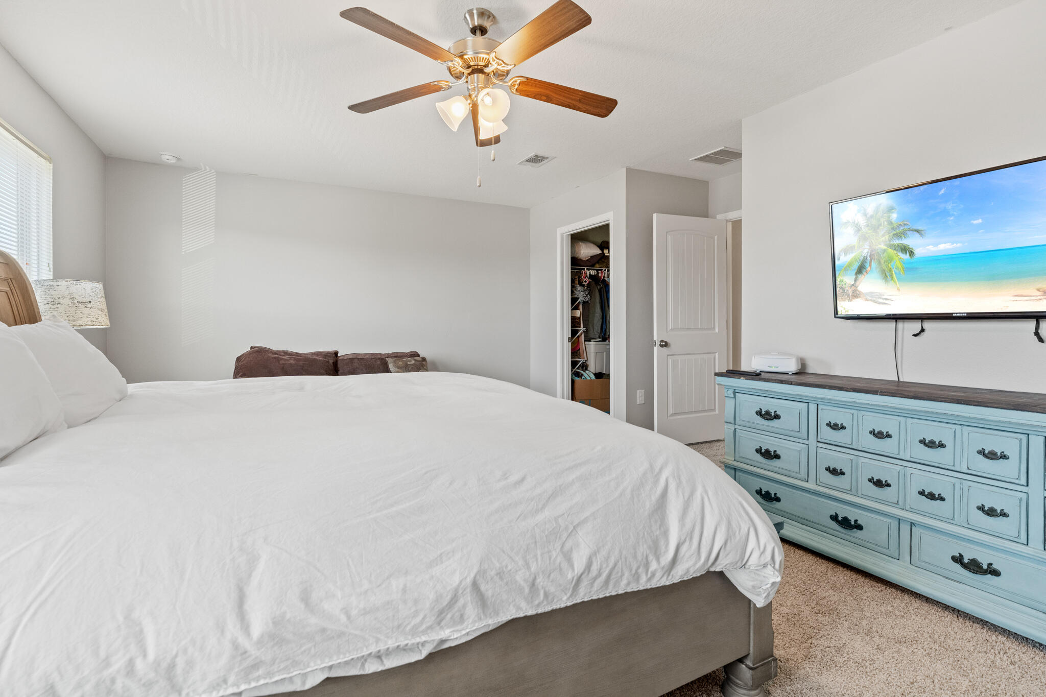 745 Widgeon Way Crestview, FL 32539 - Photo 16 of 29 a bedroom with a bed and a flat tv screen on dresser