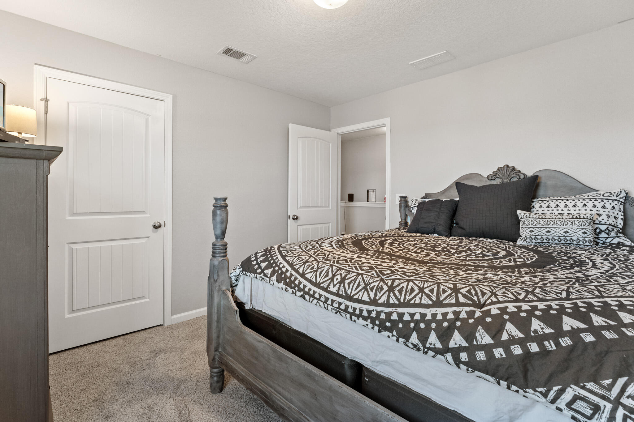 745 Widgeon Way Crestview, FL 32539 - Photo 20 of 29 a bedroom with a bed and a mirror