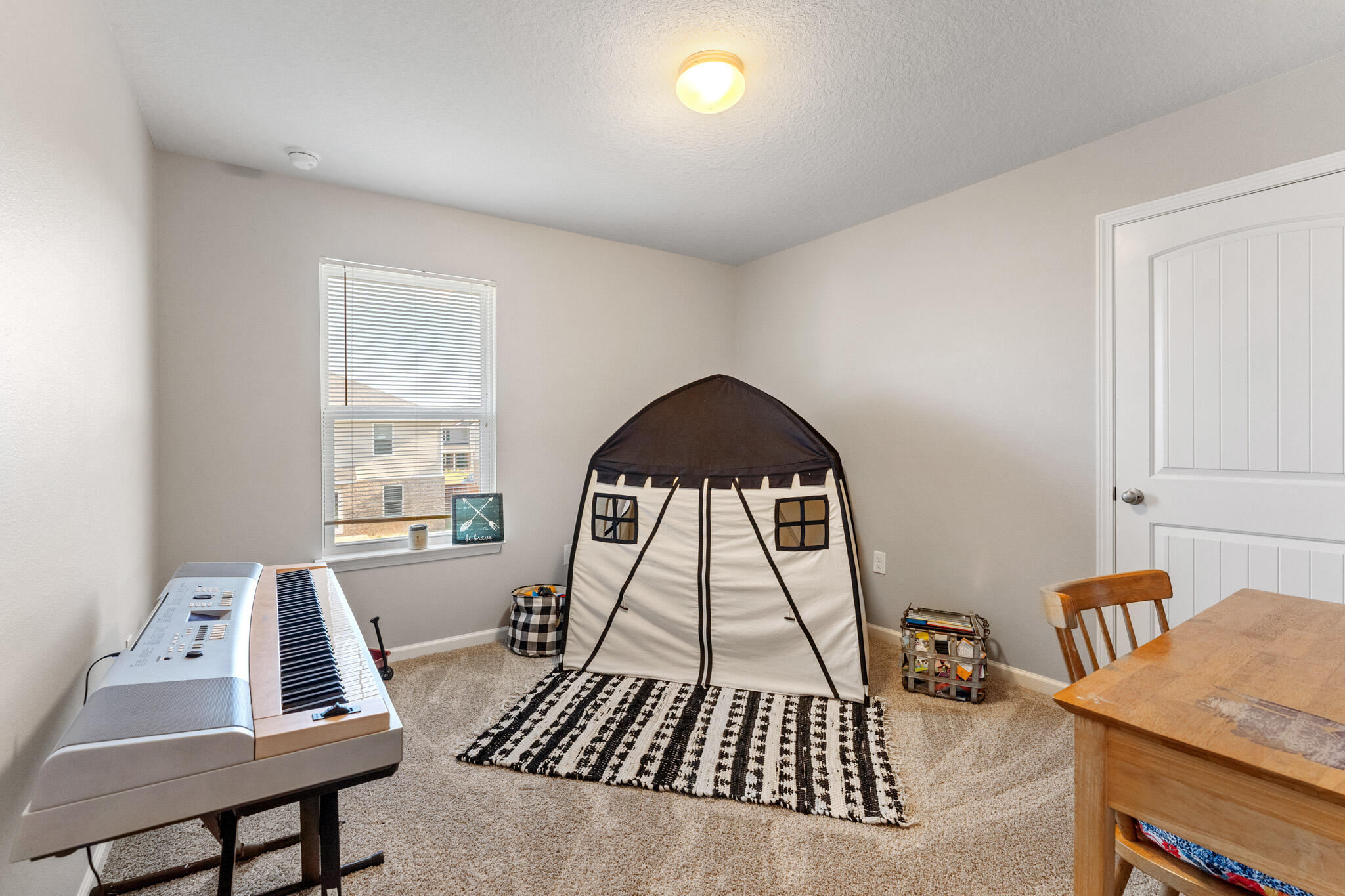 745 Widgeon Way Crestview, FL 32539 - Photo 21 of 29 a living room with a rug and a table