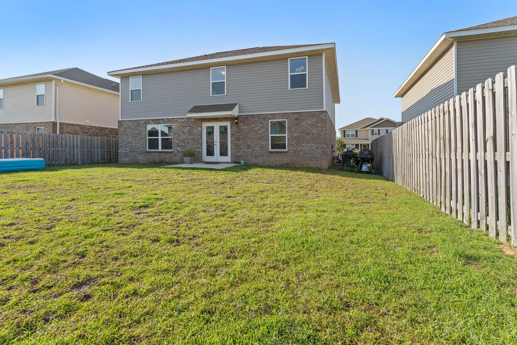 745 Widgeon Way Crestview, FL 32539 - Photo 28 of 29 a view of house with yard and retail shops