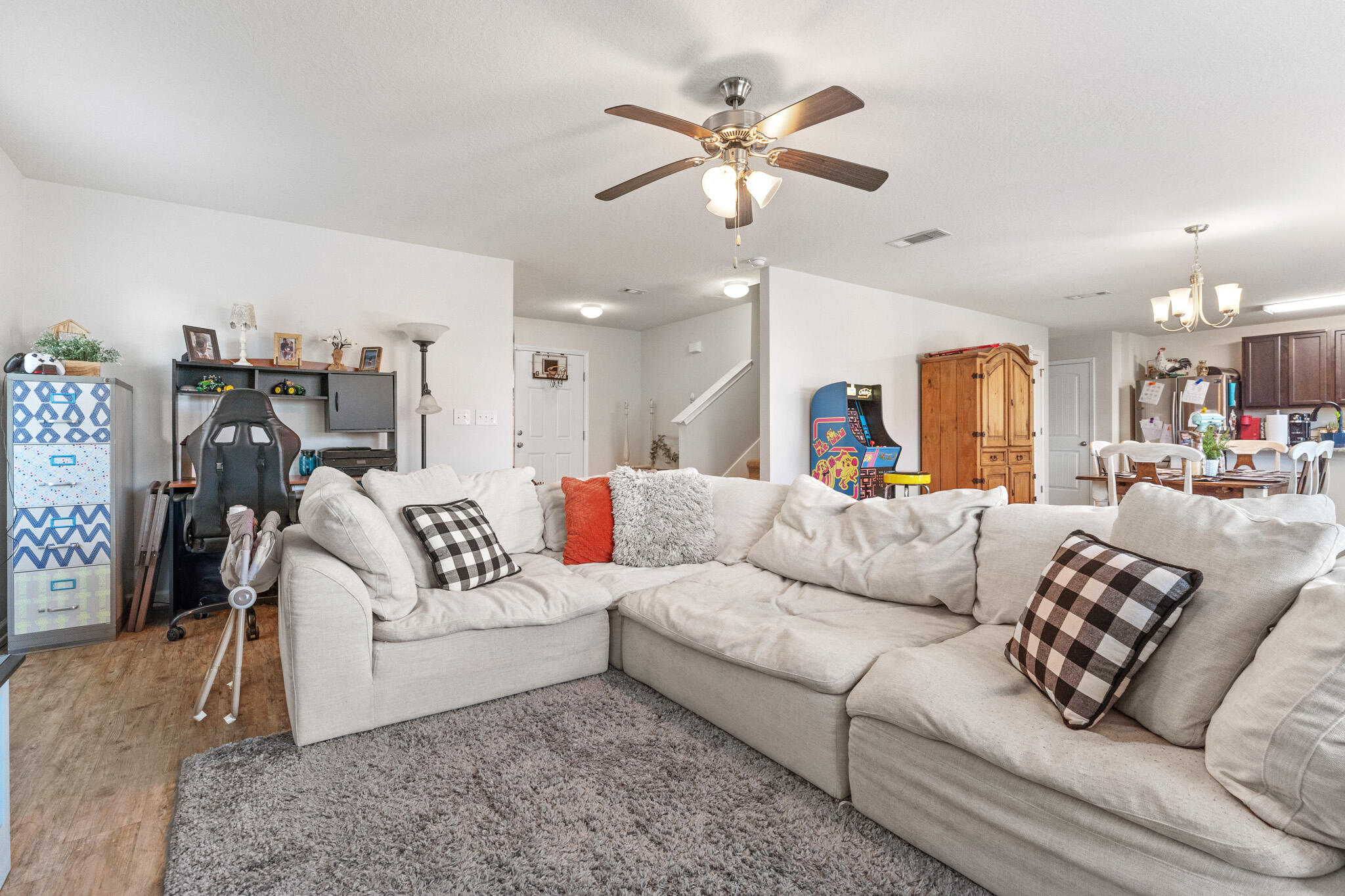 745 Widgeon Way Crestview, FL 32539 - Photo 6 of 29 a living room with furniture and a large mirror with wooden floor