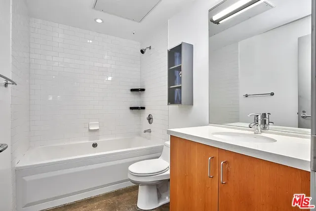 a bathroom with a sink a toilet and bathtub