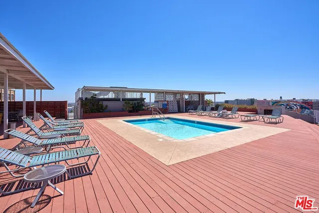 a swimming pool with outdoor seating and yard