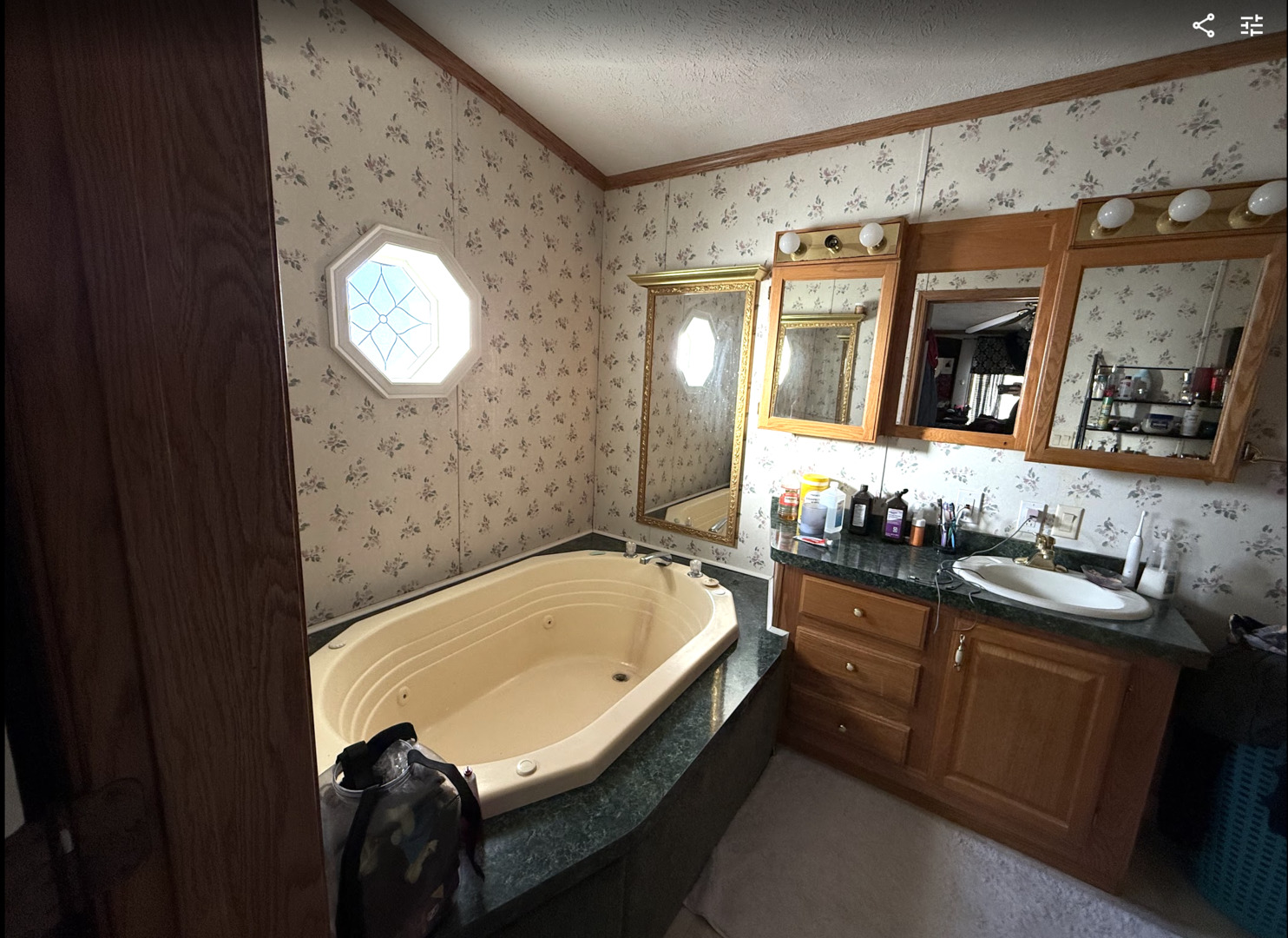 3404 Old Plank Road Park City, IL 60085 - Photo 12 of 20 a bathroom with a tub sink and mirror
