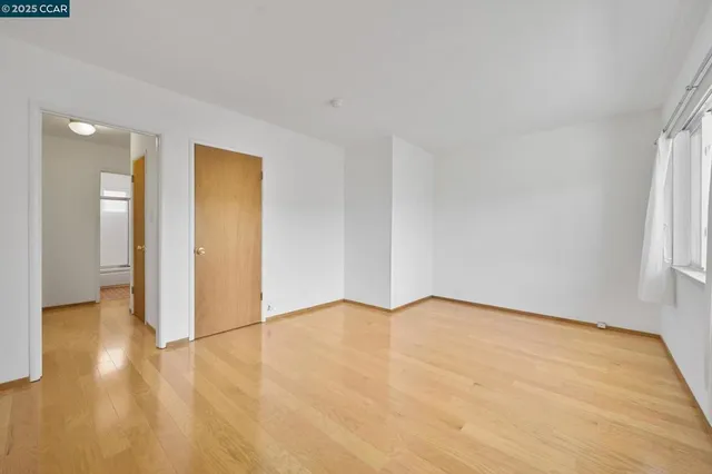 a view of an empty room and wooden floor