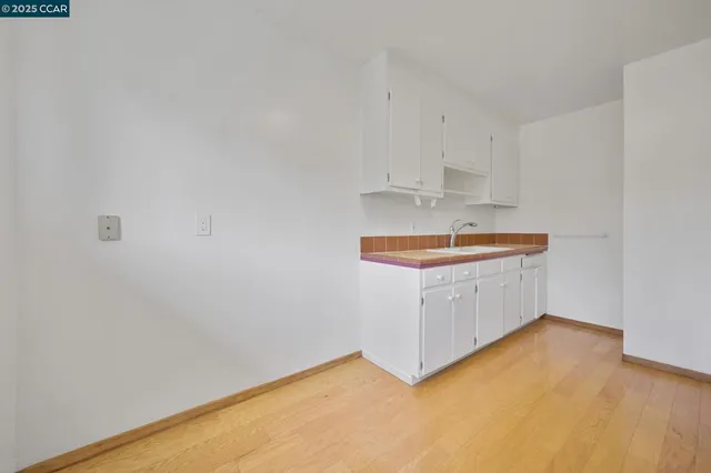 a room with a wooden floor and a sink