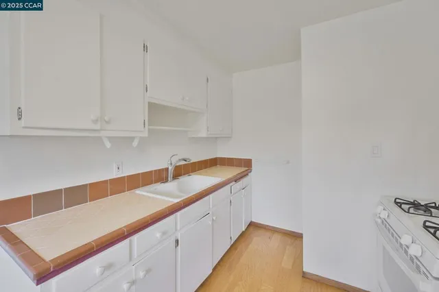 a kitchen with a sink and cabinets