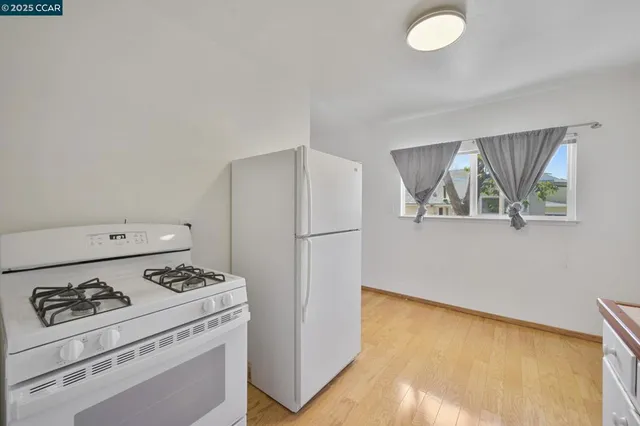 a kitchen with a stove a refrigerator and a stove