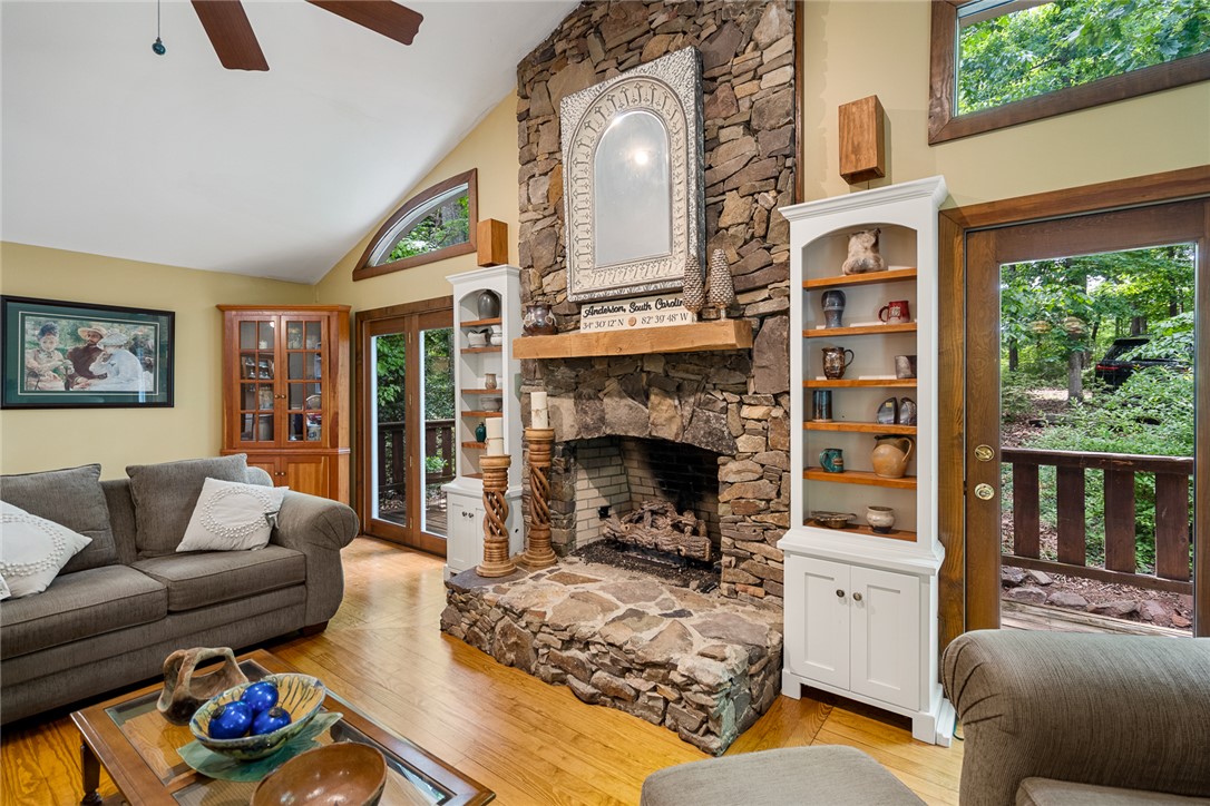 324 Hobson Road Anderson, SC 29621 - Photo 8 of 46 This inviting living area boasts a rustic stone fireplace and direct access to outdoor greenery.