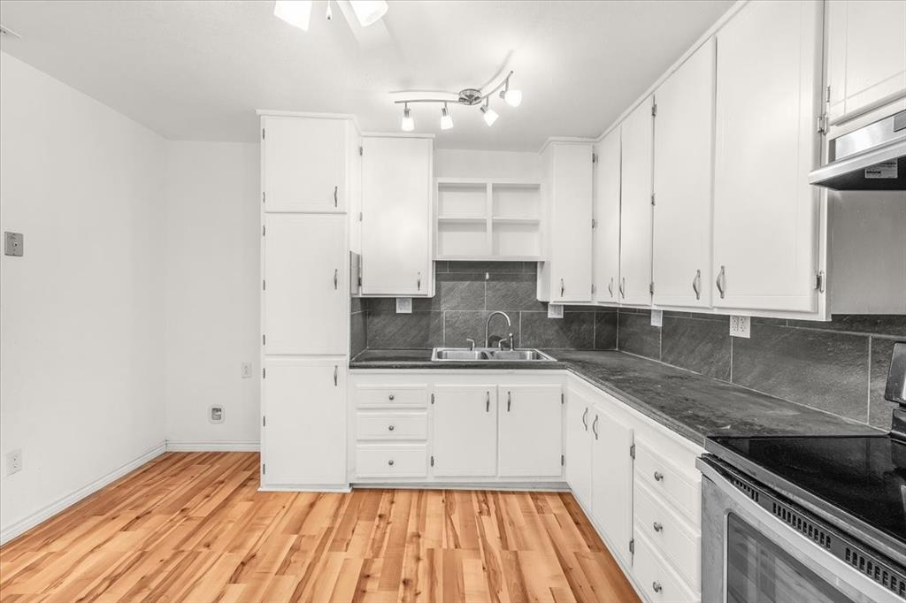 112 Del Rio Avenue, Unit A & B Benbrook, TX 76126 - Photo 12 of 33 a kitchen with granite countertop white cabinets and stainless steel appliances