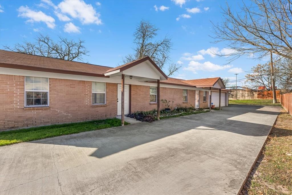 112 Del Rio Avenue, Unit A & B Benbrook, TX 76126 - Photo 4 of 33 a front view of a house with a yard and garage