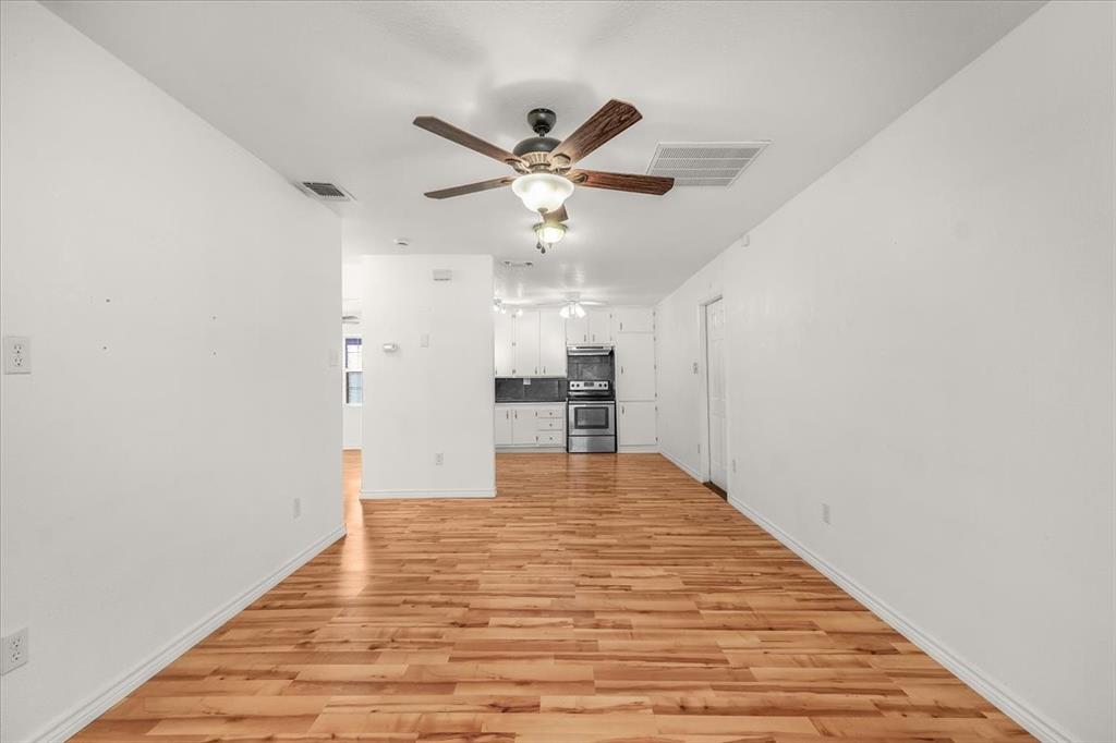 112 Del Rio Avenue, Unit A & B Benbrook, TX 76126 - Photo 9 of 33 a view of an empty room with cabinet and a ceiling fan