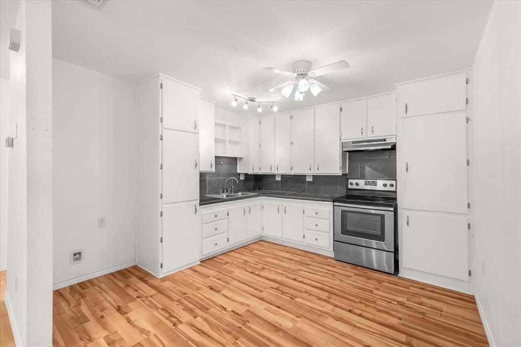 112 Del Rio Avenue, Unit A & B Benbrook, TX 76126 - Photo 10 of 33 a kitchen with granite countertop white cabinets and stainless steel appliances