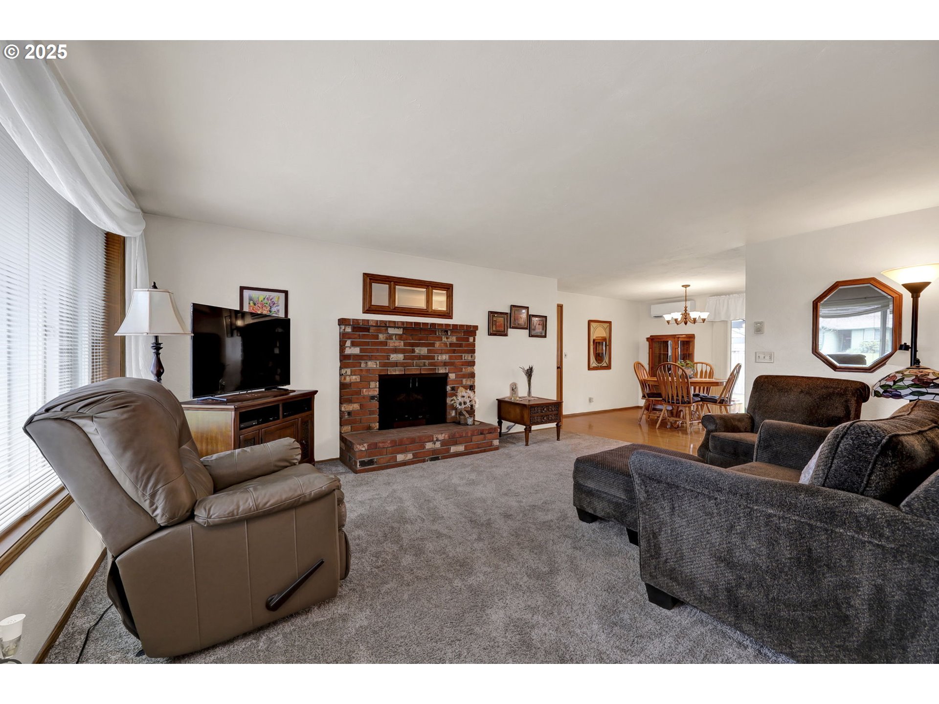 3670 Plumtree Drive Eugene, OR 97402 - Photo 13 of 47 a living room with furniture a flat screen tv and a fireplace