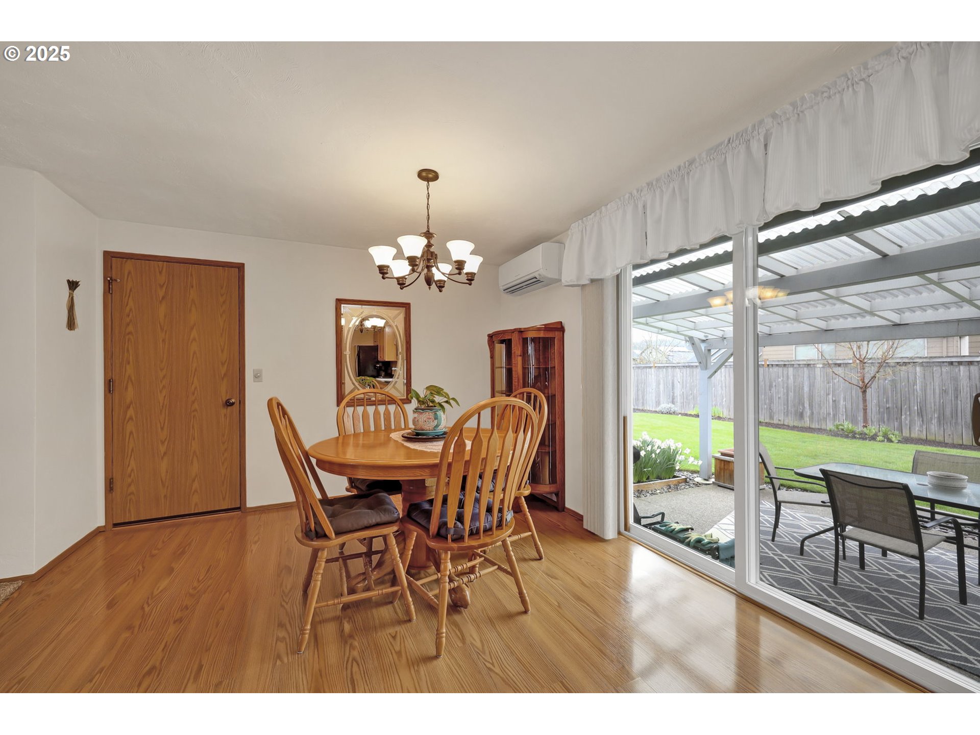 3670 Plumtree Drive Eugene, OR 97402 - Photo 21 of 47 a view of a dining room with furniture a chandelier and wooden floor