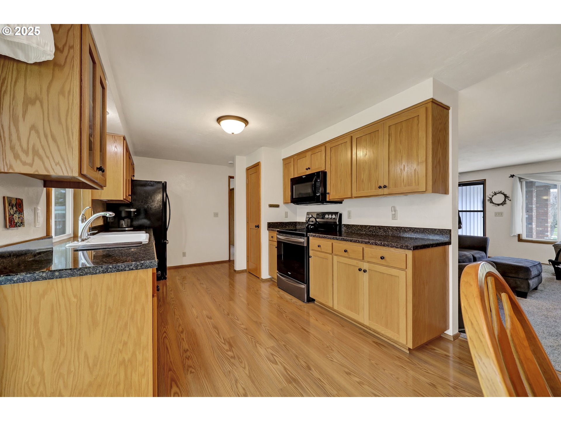 3670 Plumtree Drive Eugene, OR 97402 - Photo 22 of 47 a kitchen with stainless steel appliances granite countertop a stove top oven a sink dishwasher and cabinets with wooden floor