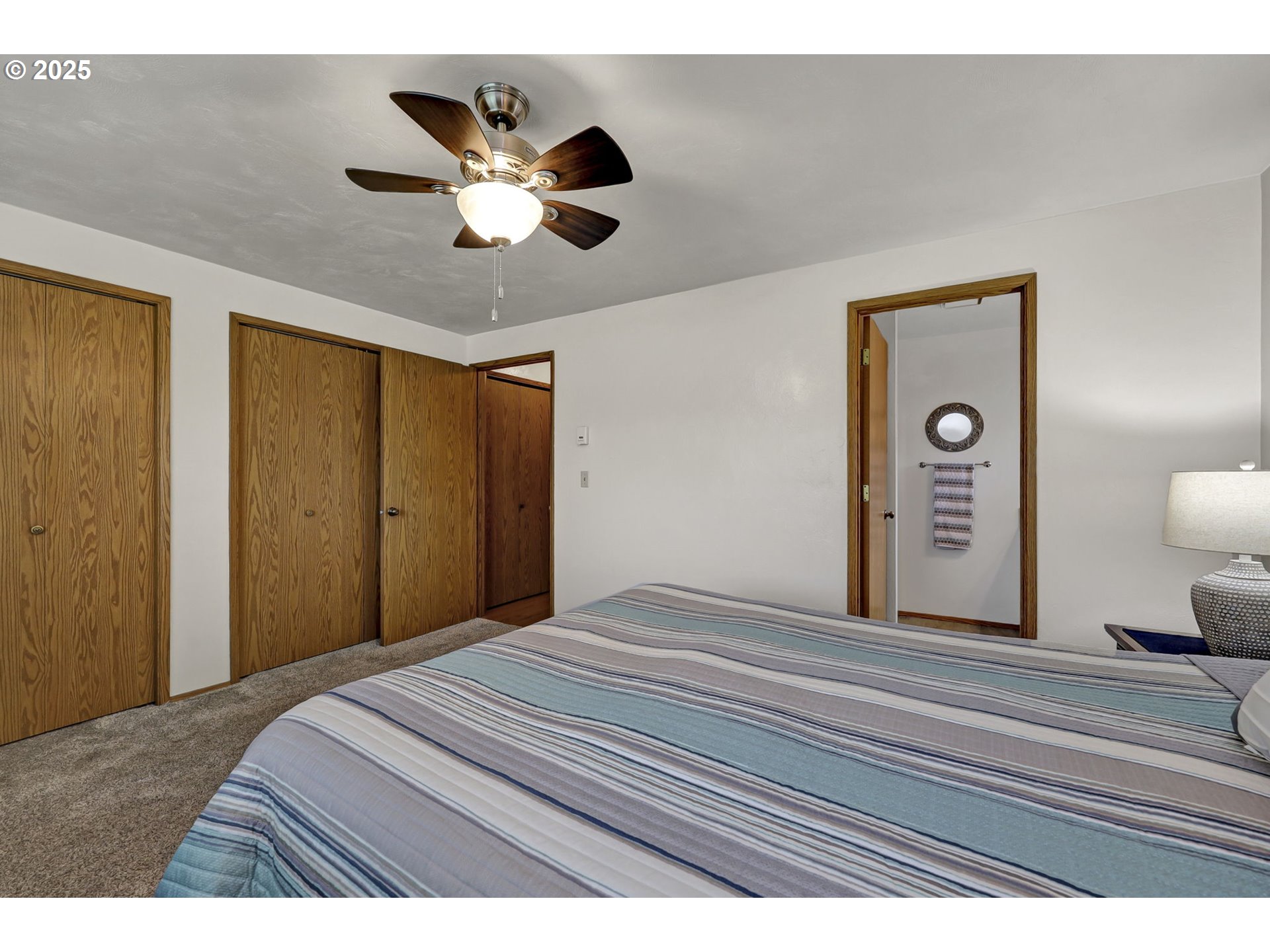 3670 Plumtree Drive Eugene, OR 97402 - Photo 27 of 47 a bedroom with a large bed and a chandelier