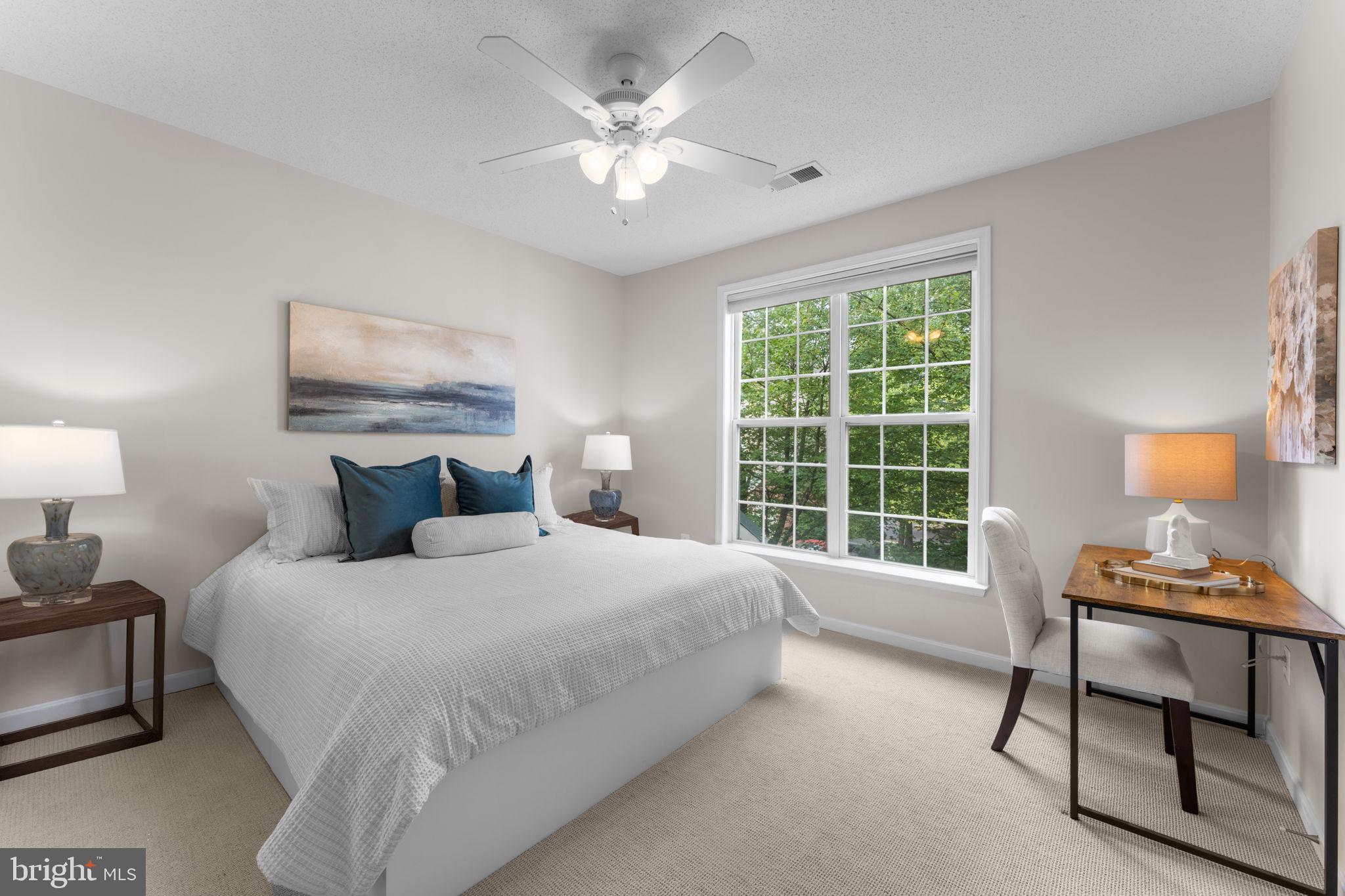 12170 Abington Hall Place, Unit 201 Reston, VA 20190 - Photo 13 of 39 a bedroom with a bed and a chair