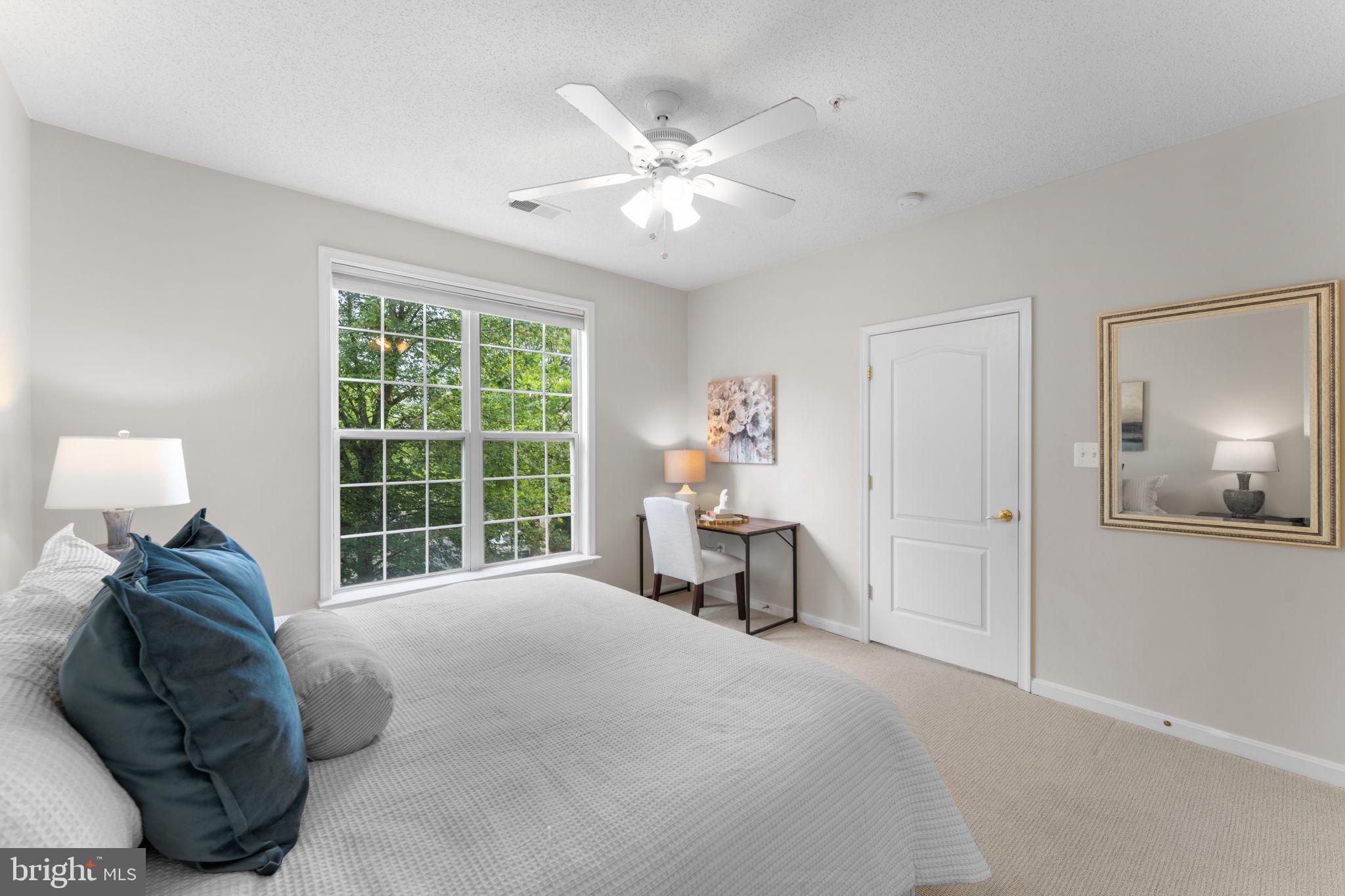 12170 Abington Hall Place, Unit 201 Reston, VA 20190 - Photo 15 of 39 a bedroom with a bed and a large window